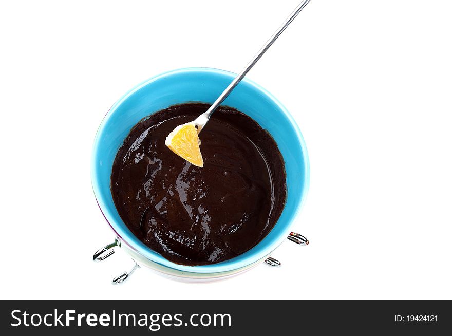 Delicious chocolate fondue with orange isolated on a white background