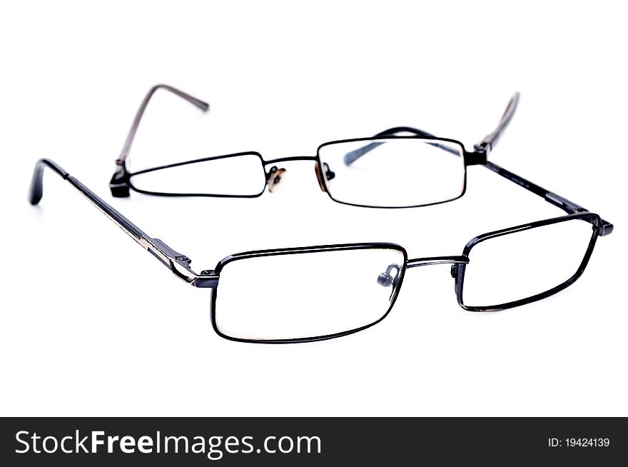 Broken black eyeglasses isolated on a white background