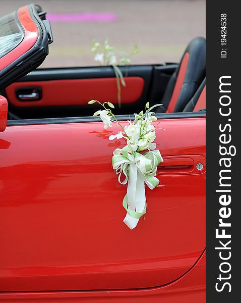 Flowers on a red wedding car. Flowers on a red wedding car