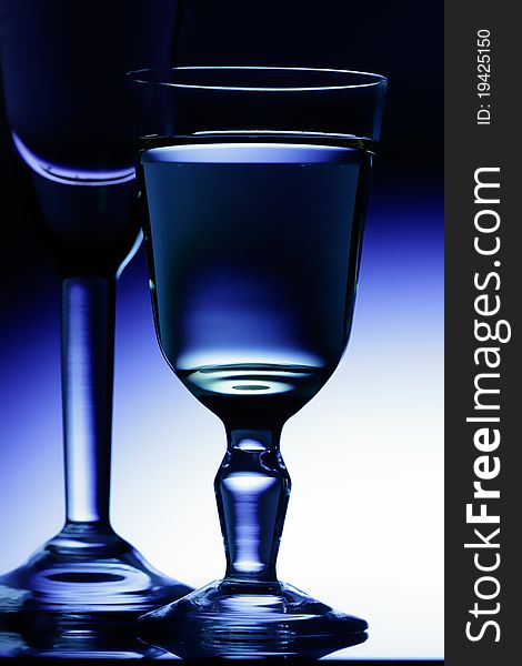 Wine-glasses on a dark blue background.