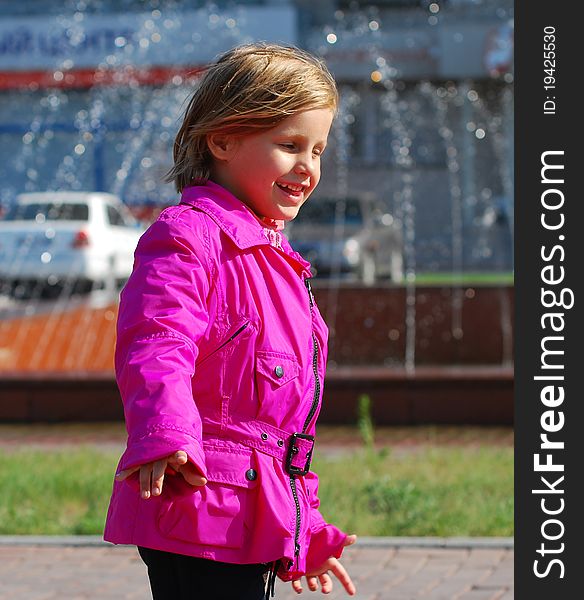 Smiling little girl walking down the street. Smiling little girl walking down the street