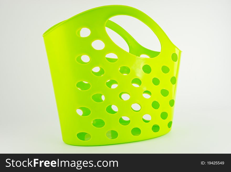 Green plastic basket isolated on white