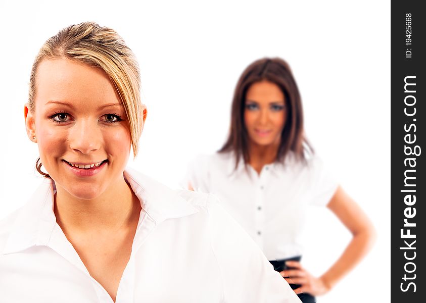 Two buisness women one completely in focus the other blurred on isloated white background. Two buisness women one completely in focus the other blurred on isloated white background