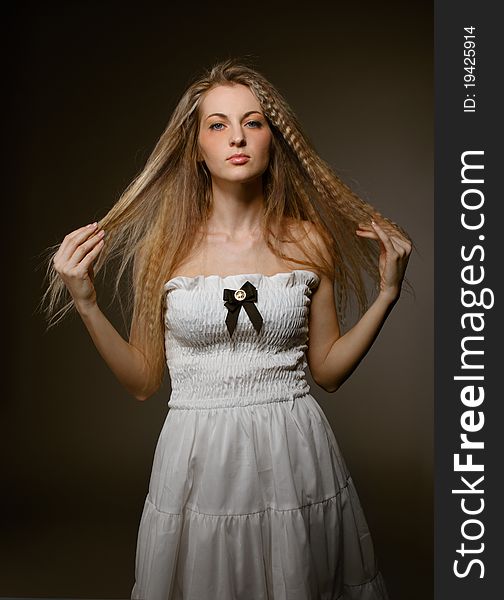 Portrait of the beauty young blond girl in white dress with make up. Portrait of the beauty young blond girl in white dress with make up