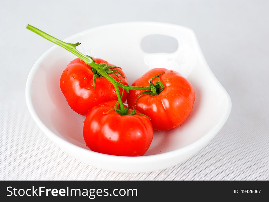 Red fresh tomatoes in the white bowl. Red fresh tomatoes in the white bowl