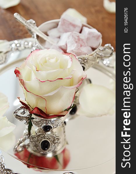 East sweets on silver ware with rose. East sweets on silver ware with rose