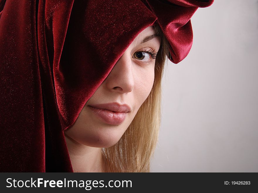 Portrait of the girl of the blonde with a fabric. Studio.