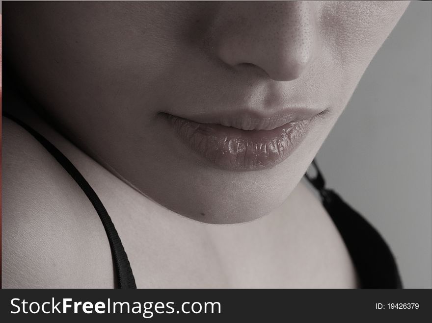 Black-and-white portrait of lips of the girl.