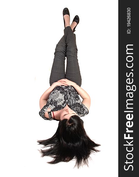 A young pretty woman lying on the floor with her legs up in the air and 
her black hair on the floor, in slakes and blouse, for white background. A young pretty woman lying on the floor with her legs up in the air and 
her black hair on the floor, in slakes and blouse, for white background.