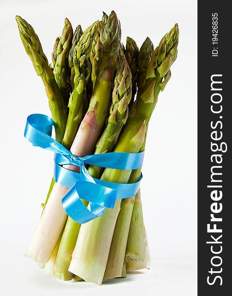 Closeup of bunch of asparagus with blue ribbon