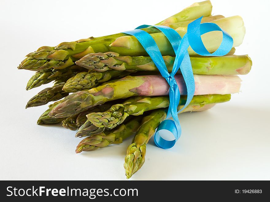 Closeup of bunch of asparagus with blue ribbon