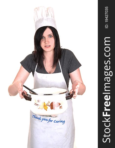 A pretty young woman, holding a hot cook pot, standing with an apron, black hair and a cook hat for white background. A pretty young woman, holding a hot cook pot, standing with an apron, black hair and a cook hat for white background.