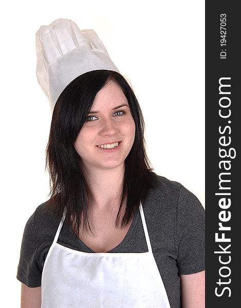 A lovely portrait of a young woman with an apron and cooking hat, smiling into the camera for white background. A lovely portrait of a young woman with an apron and cooking hat, smiling into the camera for white background.