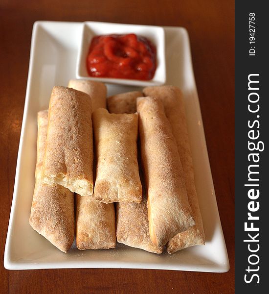Bread sticks with tomato sauce. Very appetitive.