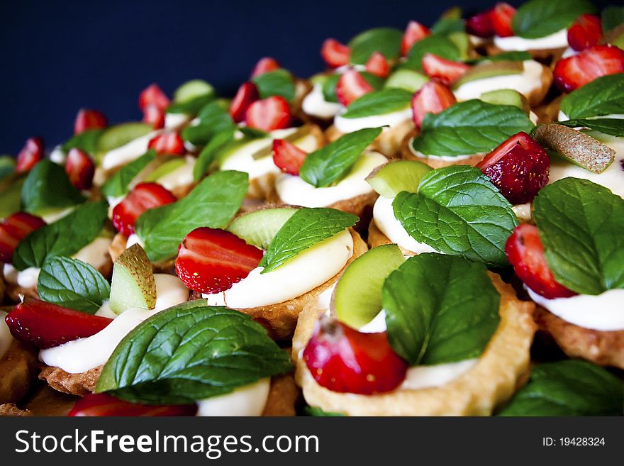 Group of sweet flans with fresh fruit and mint leaf. Group of sweet flans with fresh fruit and mint leaf