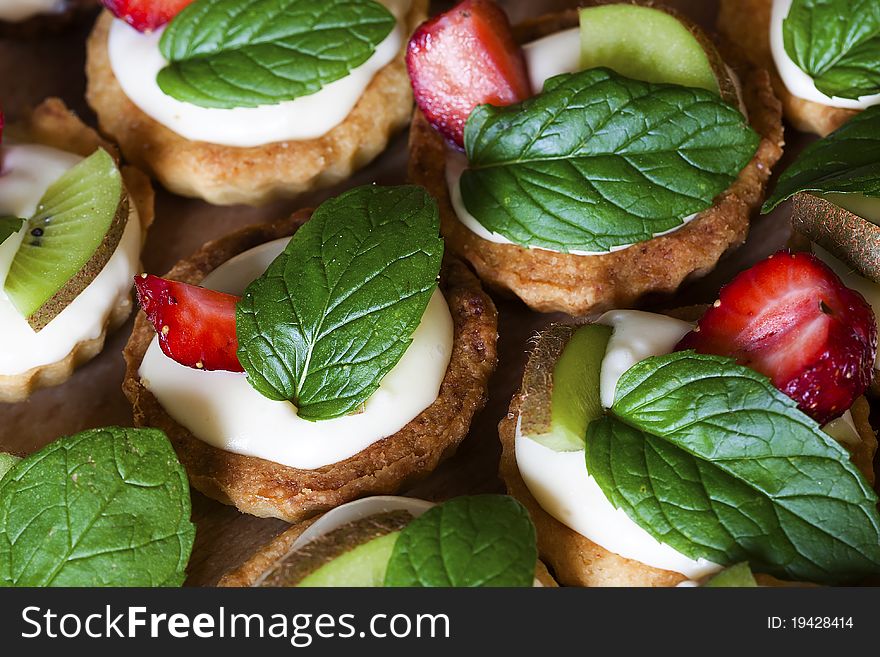 Group of sweet flans with fresh fruit and mint leaf. Group of sweet flans with fresh fruit and mint leaf