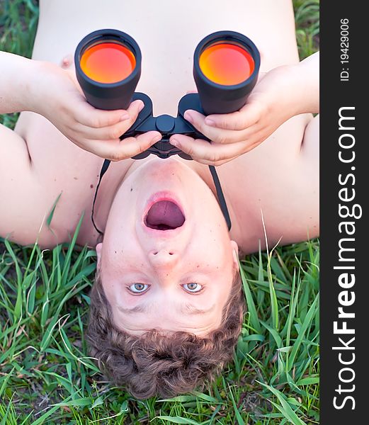 Portrait of a young man looking through a binocular. Portrait of a young man looking through a binocular.