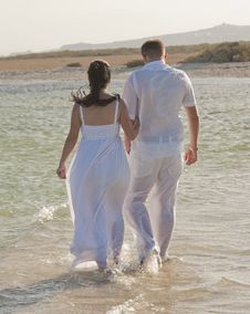 Young Newlyweds Walking On A Tropical Beach Stock Photos Young Newlyweds Walking On A Tropical Beach Stock Photos