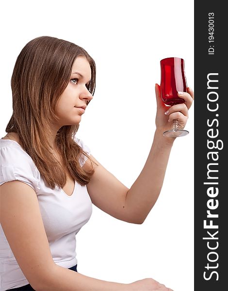 A girl in a bright red T-shirt and a glass sitting on a white background