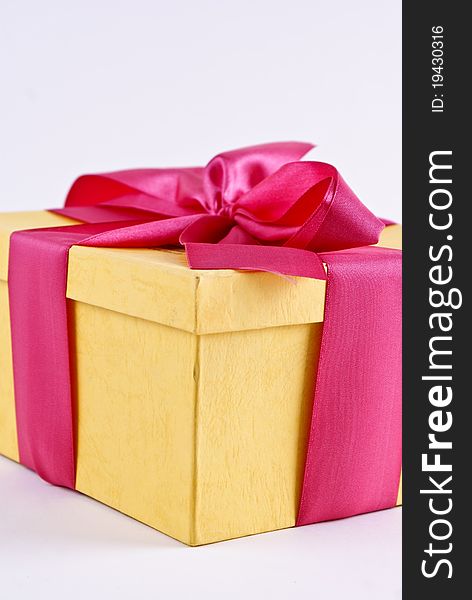 Yelloy present box with ribbon bow isolated over white background