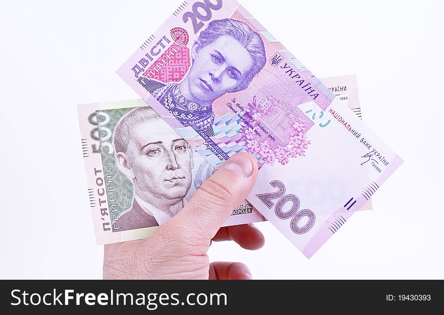 Ukrainian money is hryvnya in hand on white background