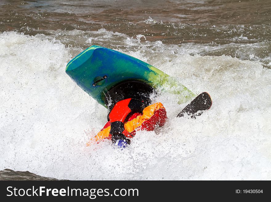 Kayaker making loop, freestyle kayak competition