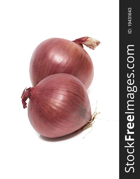 A couple of red onions isolated on a white background. A couple of red onions isolated on a white background.