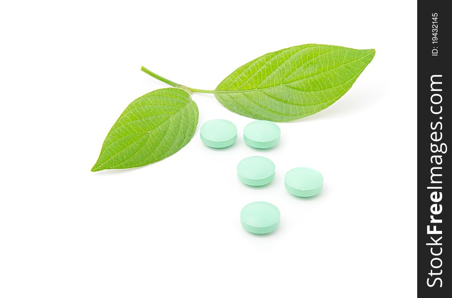 Pills with green leaf isolated on a white background. Herbal Medicine.