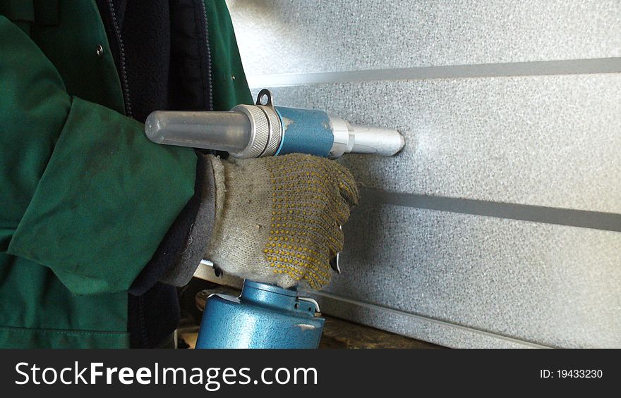 Man using a rivet gun