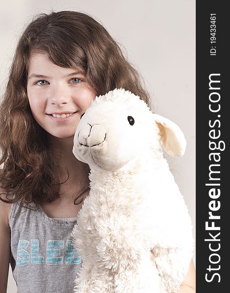 Young girl with a stuffed animal sheep lamb as her best friend. Young girl with a stuffed animal sheep lamb as her best friend