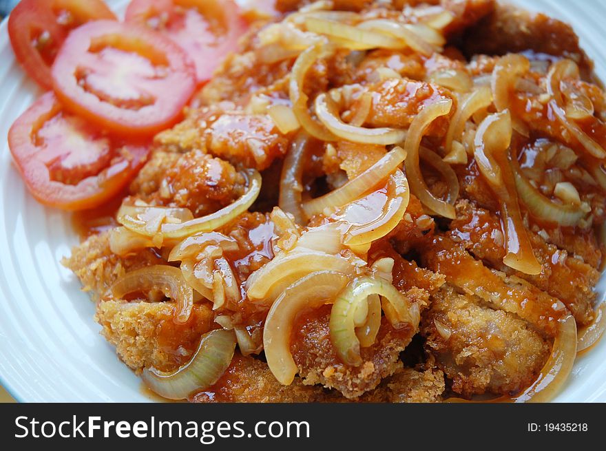 Image of pork chop with sauce tomato