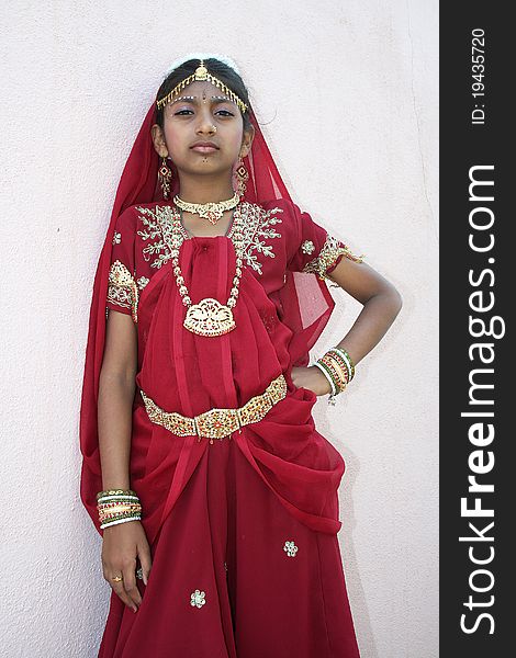 Girl wearing ornaments on head, neck, waist and hand in red dance costume. Girl wearing ornaments on head, neck, waist and hand in red dance costume