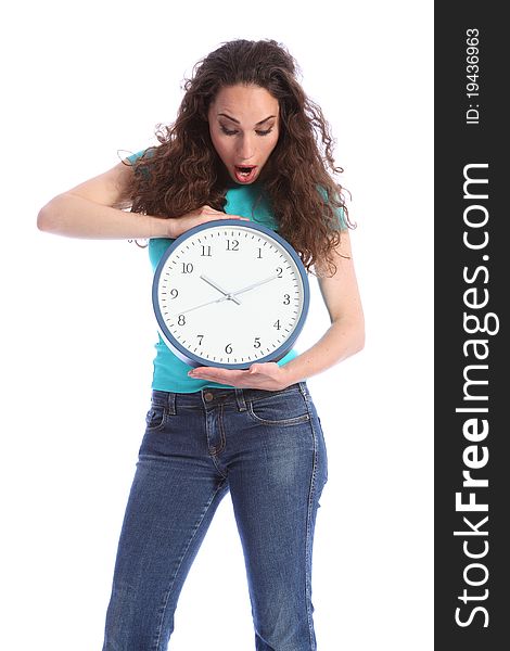 Surprised at the time, a beautiful young woman holding a large clock. She has long brown hair and is wearing blue jeans and turqoise t-shirt. Surprised at the time, a beautiful young woman holding a large clock. She has long brown hair and is wearing blue jeans and turqoise t-shirt.
