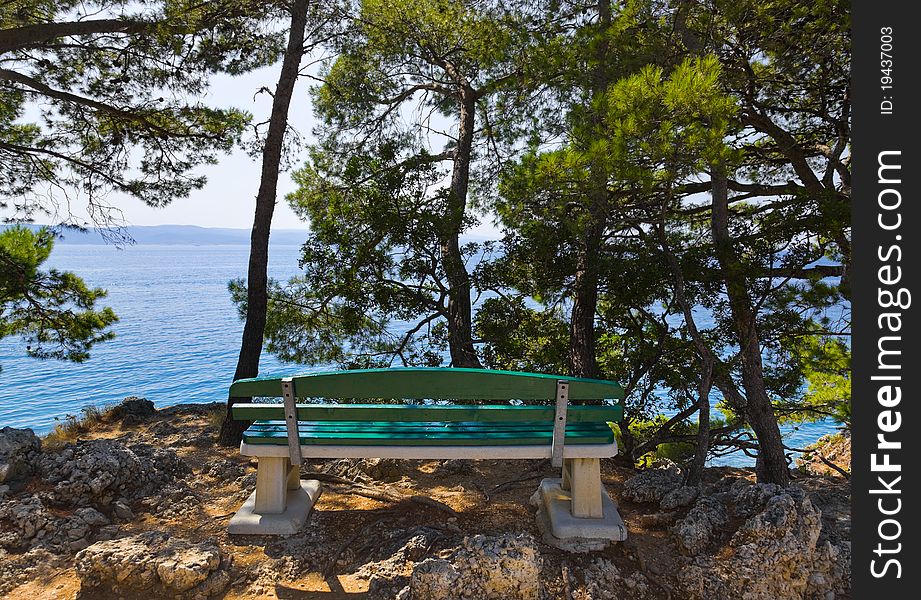 Coast, bench and sea at Brela, Croatia - vacations background