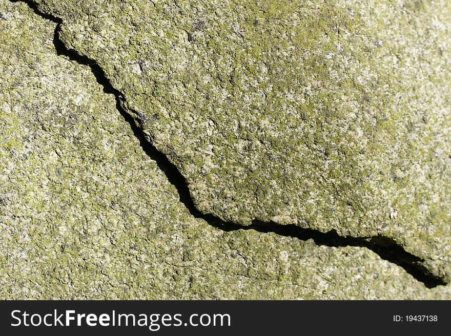 Rock with big crack and green lichen. Rock with big crack and green lichen