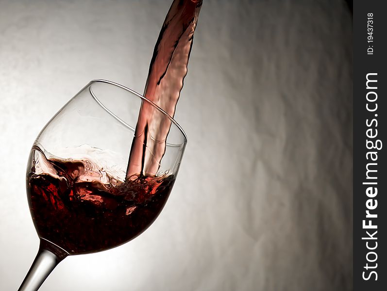 Wine being poured smoothly into a wine glass. Wine being poured smoothly into a wine glass