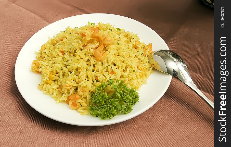 Eating fried rice using a spoon isolated in solid white background.