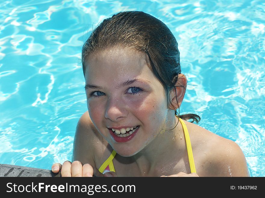 Young happy girl in the pool during summertime. Young happy girl in the pool during summertime