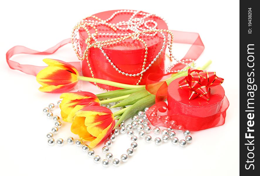 Bouquet of tulips and gift on a white background