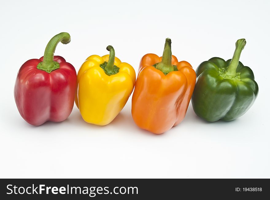 Four Peppers, red, yellow, orange & green on a white background. Four Peppers, red, yellow, orange & green on a white background