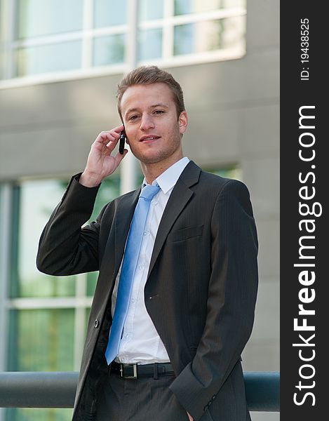 Young business man with a telephon at an office district