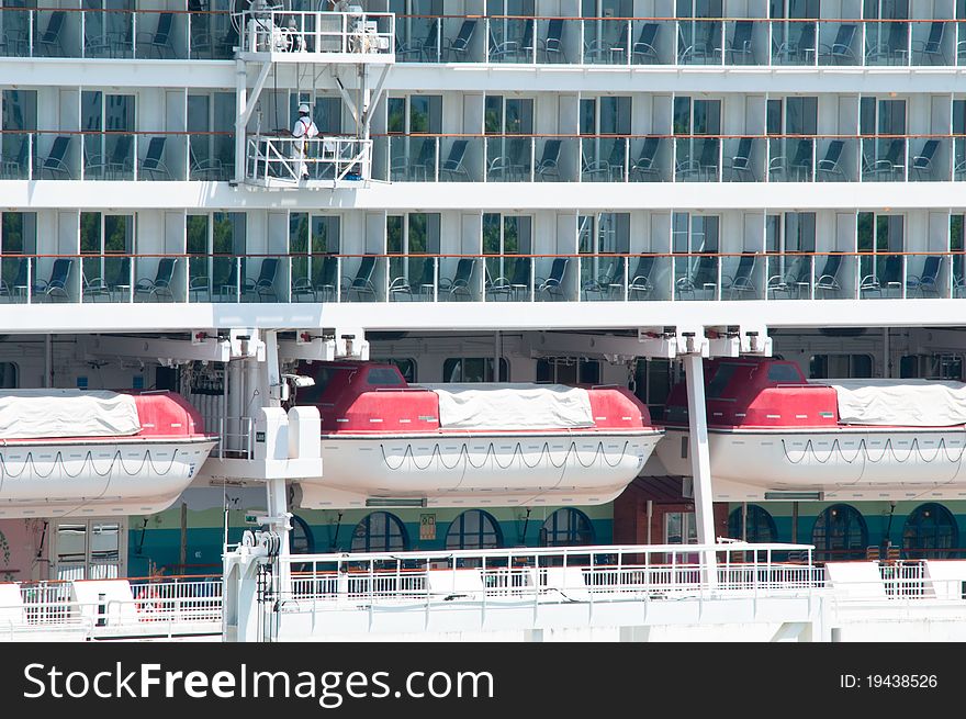 A maintenance in progress for a passenger cruise ship. This picture shown rows and levels of balcony class room and rows of safety boat.