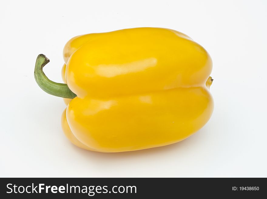 Single yellow pepper on a white background