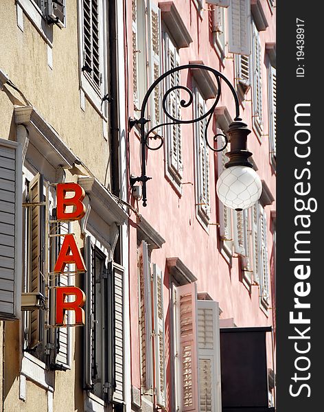 Architecture detail, street lamp and bar sign  in Trieste, Italy