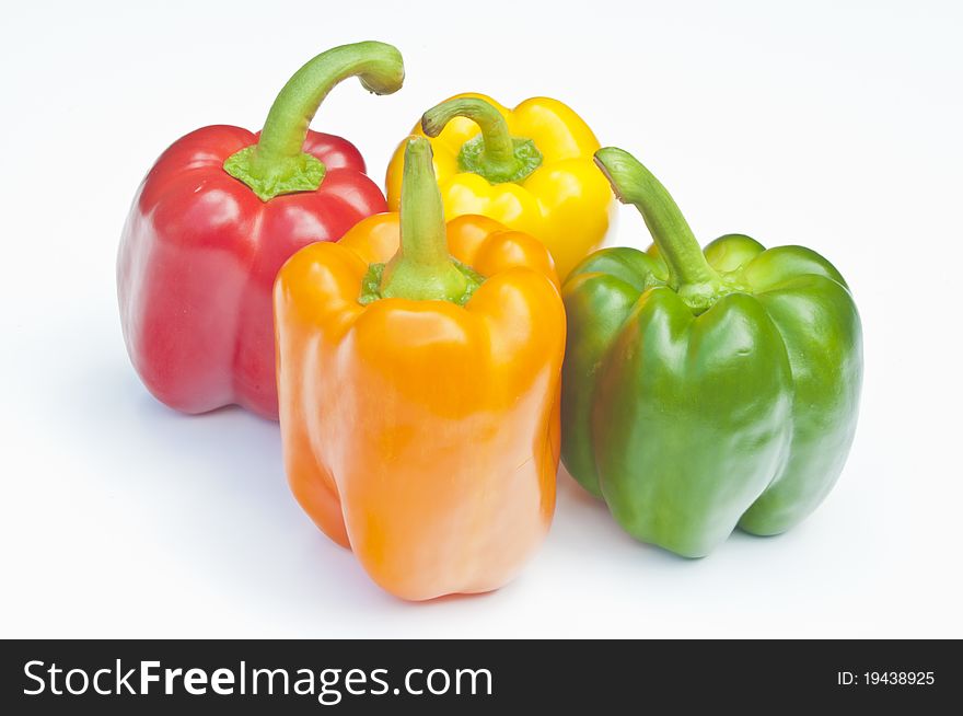 Four Peppers, red, yellow, orange & green on a white background. Four Peppers, red, yellow, orange & green on a white background