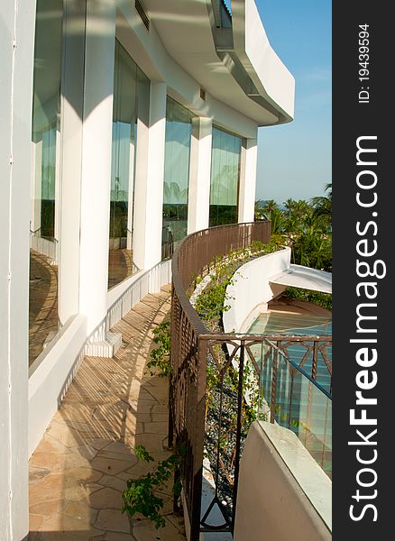 A portrait of resort building long balcony with a big glass window for natural lighting,. A portrait of resort building long balcony with a big glass window for natural lighting,