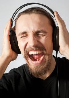 Guy Listening To The Music And Screaming Stock Photo