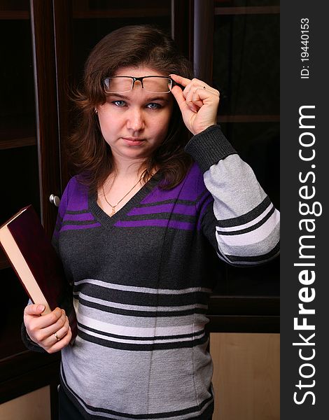 Pretty brunet girl with book and glasses posing. Pretty brunet girl with book and glasses posing.