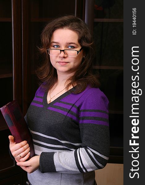 Pretty brunet girl with book and glasses posing. Pretty brunet girl with book and glasses posing.