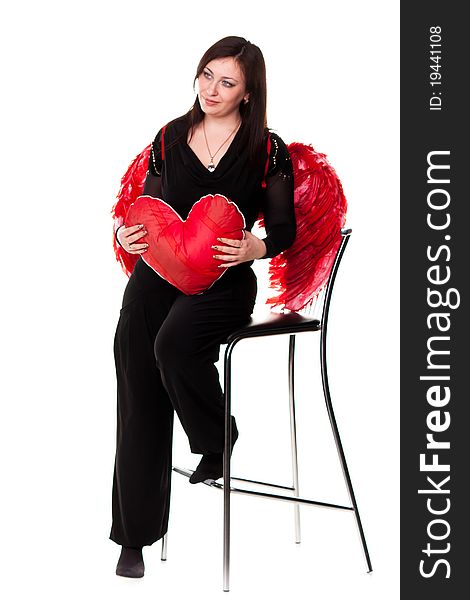 Beautiful woman with red heart in red angel wings isolated on white